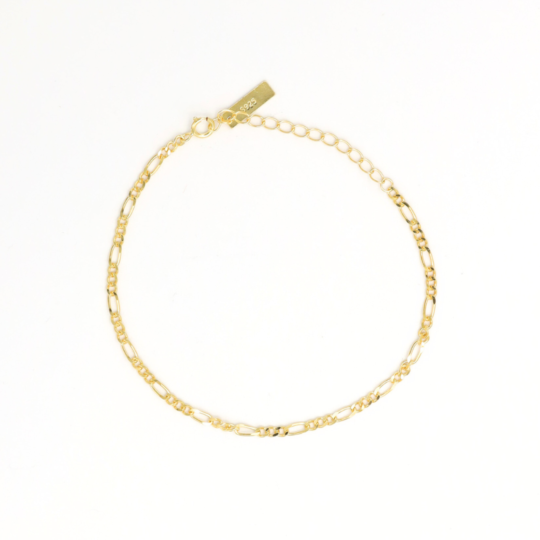 A gold-colored bracelet with a chain link design on a white background.