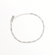 A silver bracelet with multiple interlinked chains laid out on a white background.