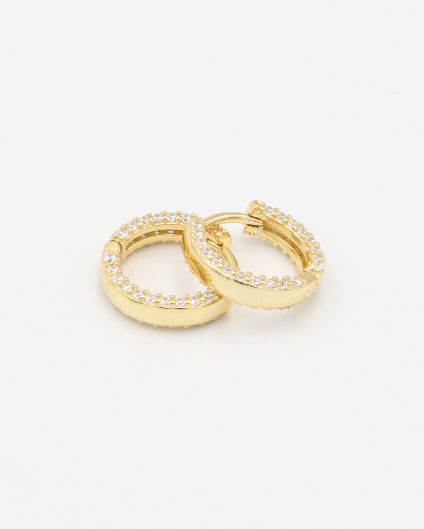 Close-up of Mara gold-plated sterling silver hoops, showcasing the zirconia-studded design for a luxurious finish.