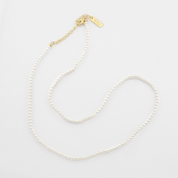 A pearl necklaces on a light gray background