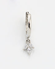 A silver-colored hoop earring with a hinged clasp and a dangling decorative element.