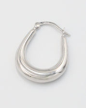 A pair of silver hoop earrings with a latch back clasp on a white background.