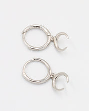 A silver-colored hoop earring with a hinged clasp and a small crescent moon charm attached to it.