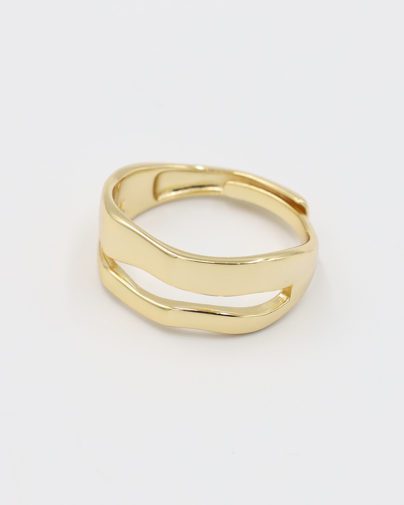 A single gold-colored ring with a smooth, curved design on a white background.