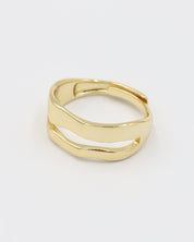 A single gold-colored ring with a smooth, curved design on a white background.