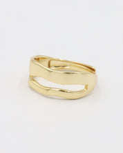 A single gold-colored ring with a smooth, curved design on a white background.