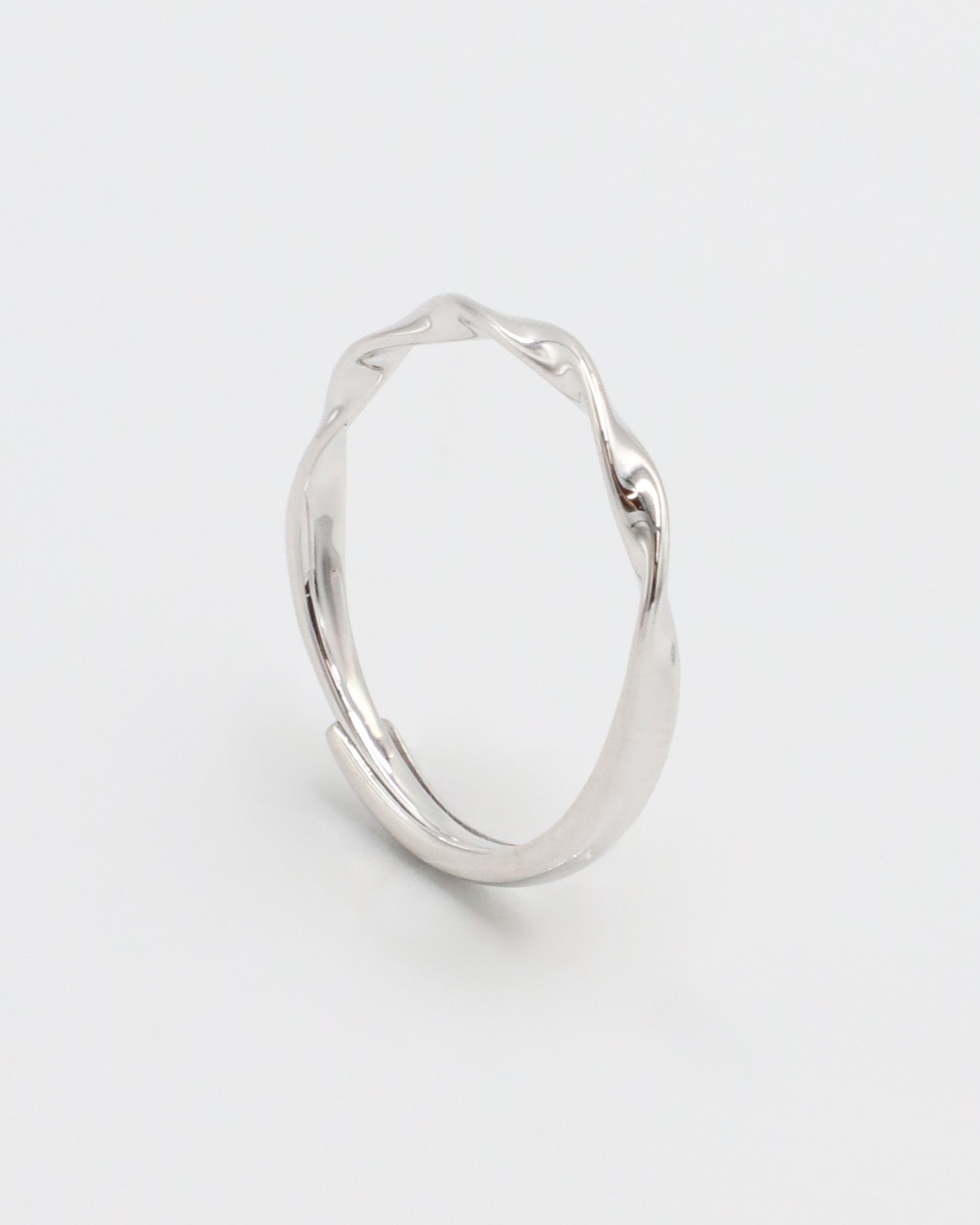 A silver ring with a simple, modern design displayed against a white background.