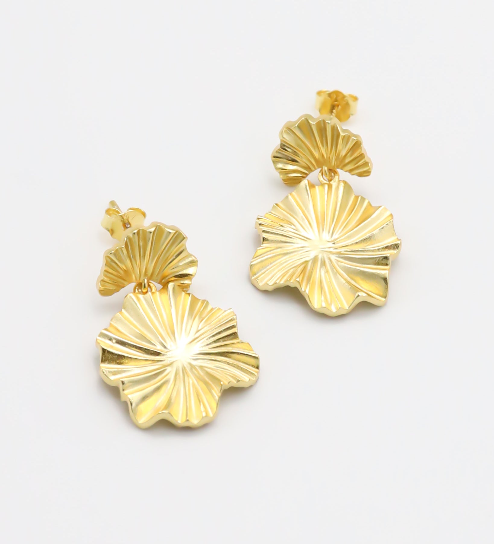 A pair of gold-colored floral design earrings with a butterfly clasp closure.