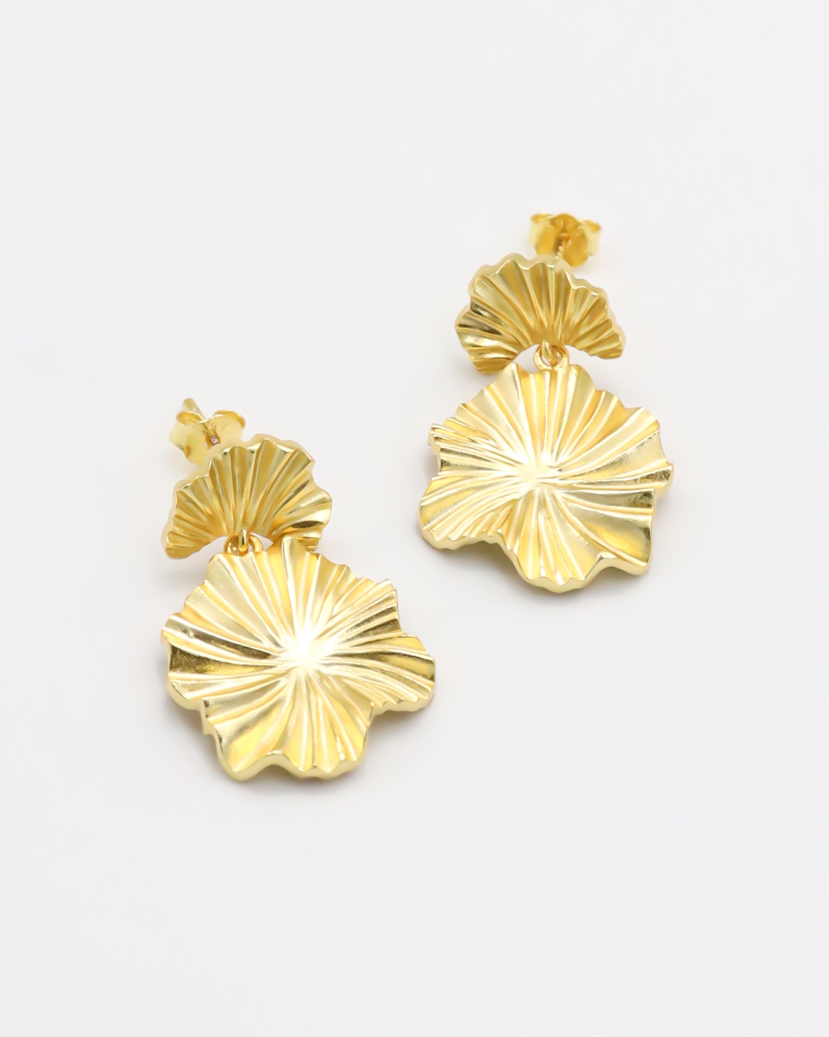 A pair of gold-colored floral design earrings with a butterfly clasp closure.