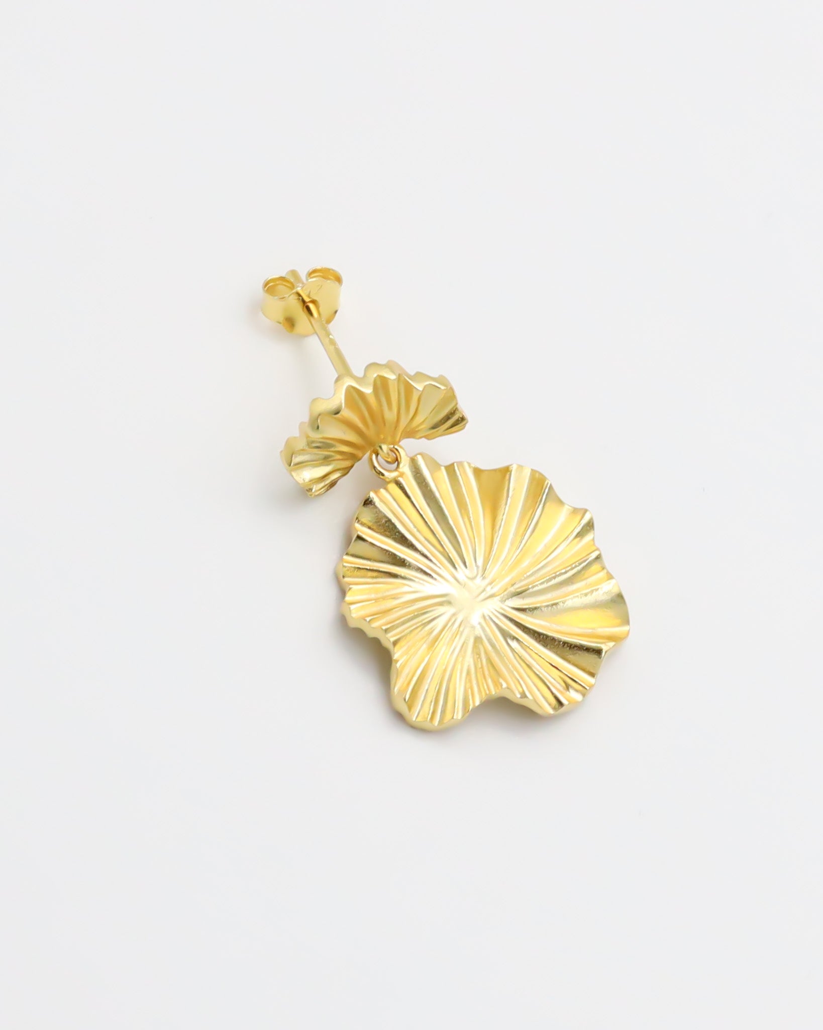 A single gold-colored floral design earring with a butterfly clasp closure.