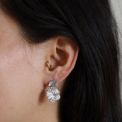 Close-up of an ear wearing the Miri Earring in the lobe and the Lu hoop in the tragus piercing.