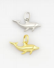 Gold and silver dolphin pendants on a white background