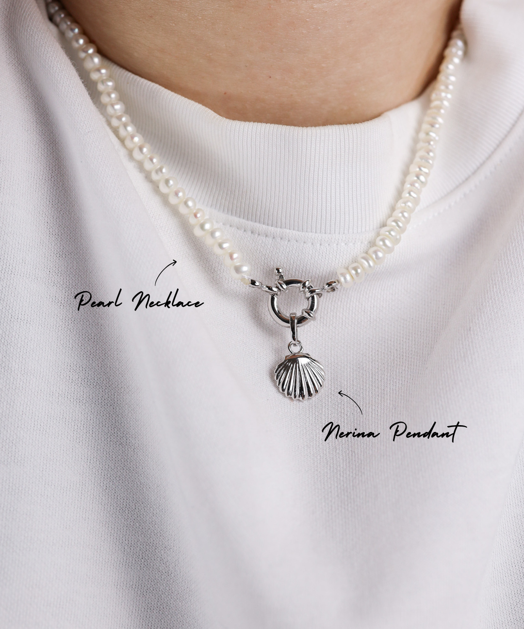 Pearl necklace with a silver pendant on a white shirt