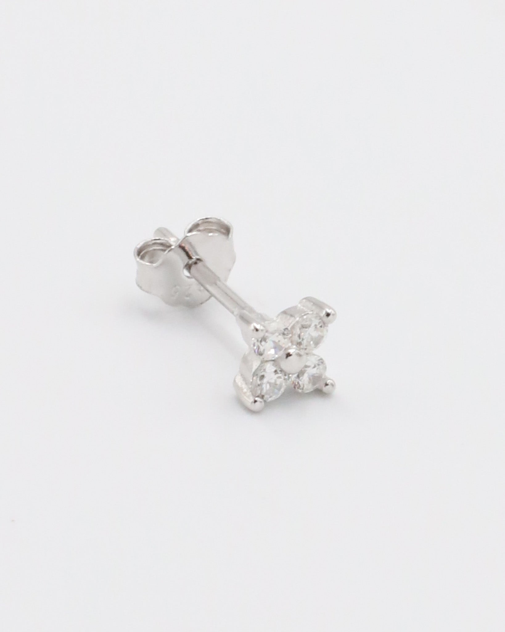 A pair of silver hoop earrings with a crystal embellishment in the center.