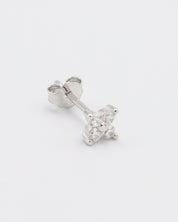 A pair of silver hoop earrings with a crystal embellishment in the center.