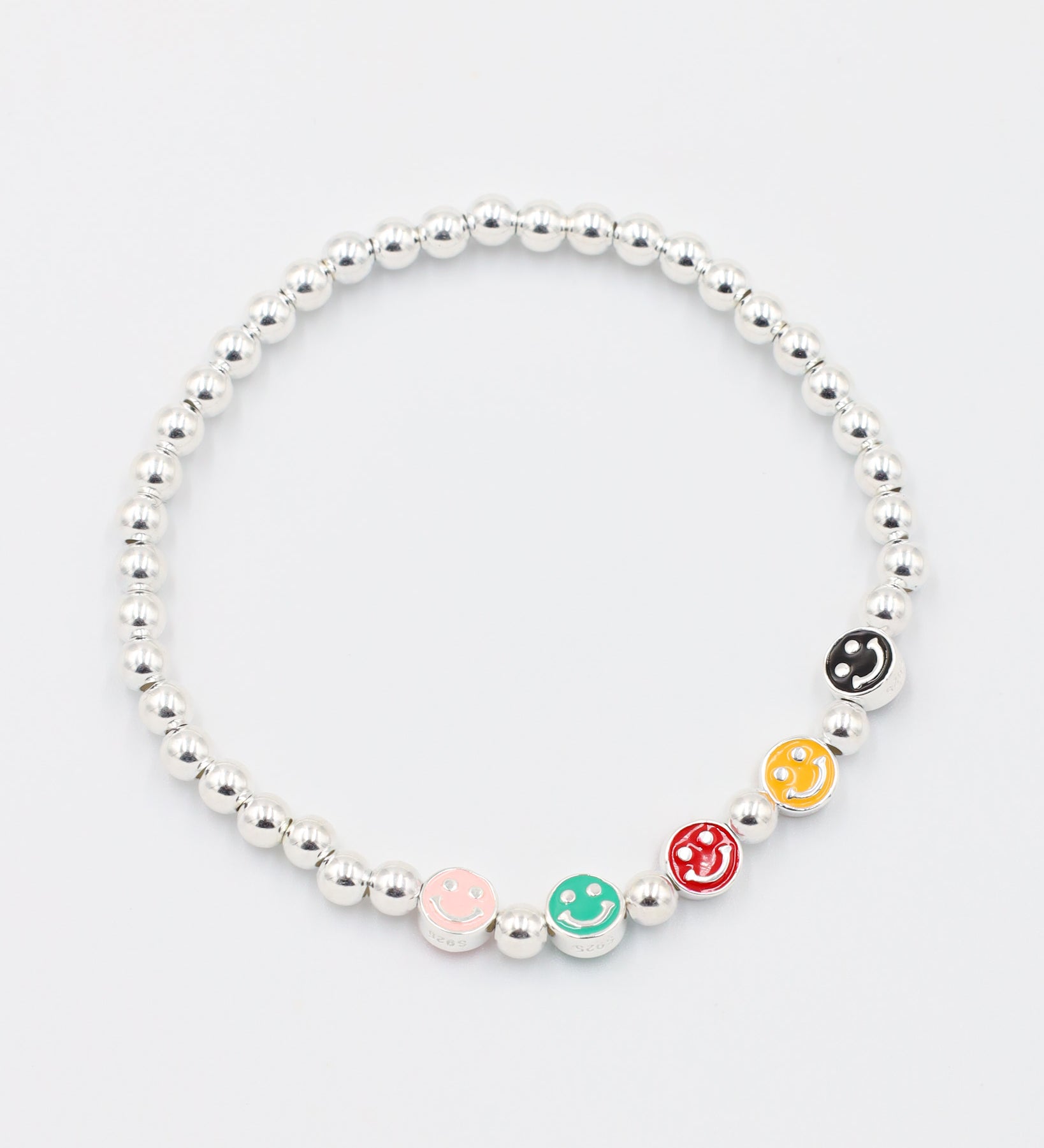 Top view of adjustable sterling silver bracelet with colored smiley face beads and round silver beads.