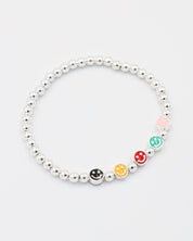 Side view of adjustable sterling silver bracelet with five colorful smiley face beads and silver beads.