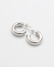 A pair of silver hoop earrings with a pressure system anchoring, displayed against a white background.