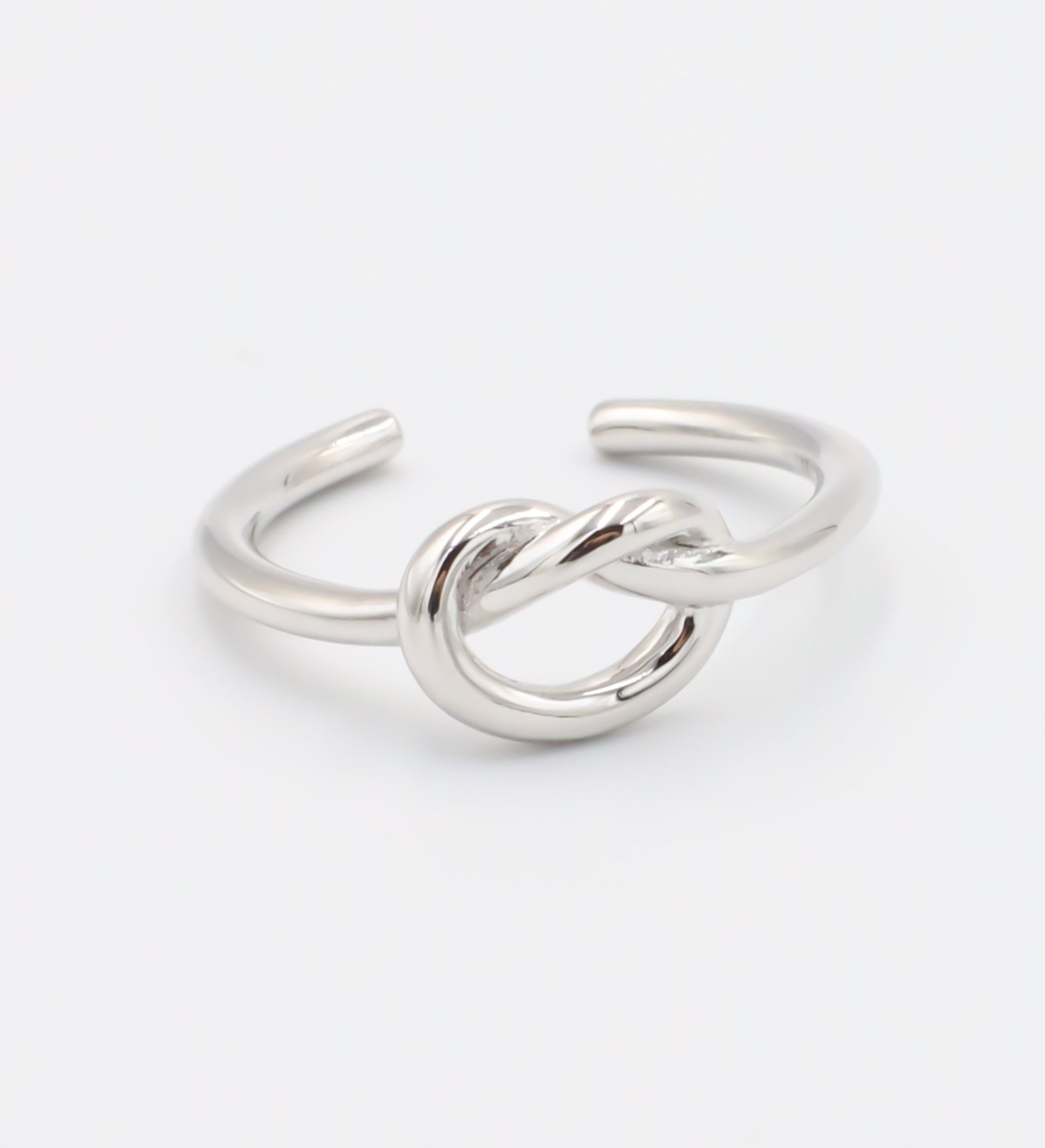 An adjustable silver ring with a infinity symbol design