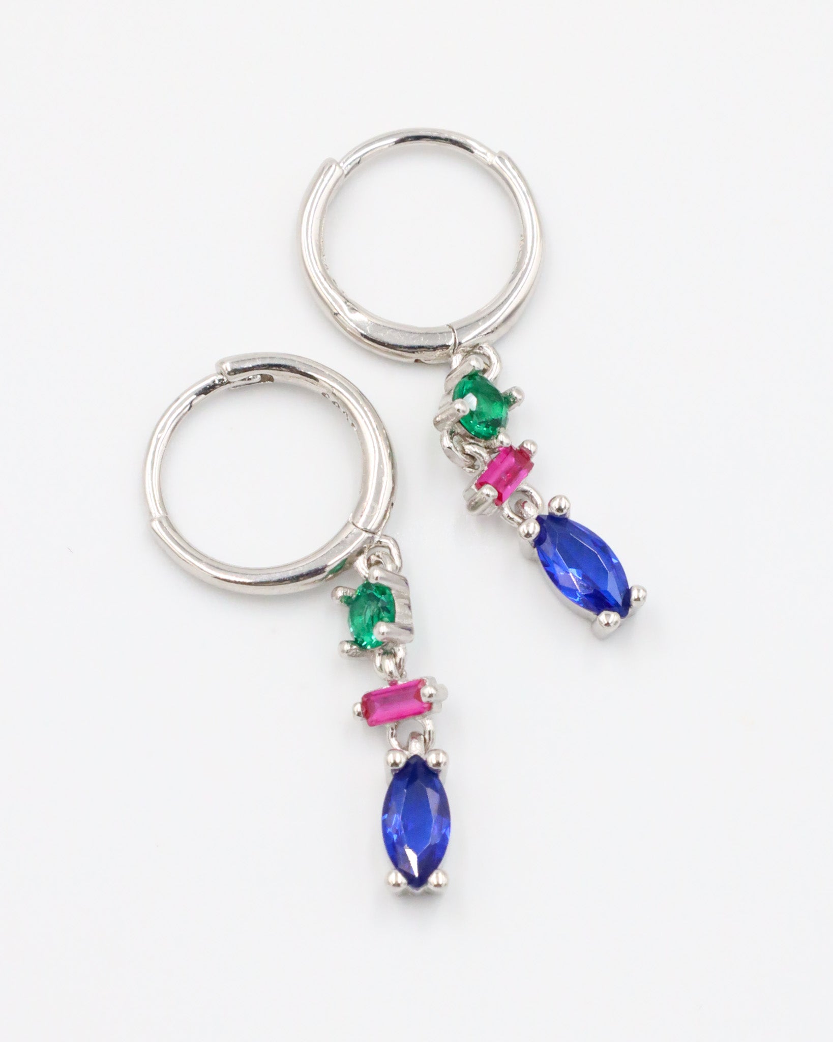 Pair of Phoebe sterling silver earrings with blue, pink, and green stones, shown in a flat lay.