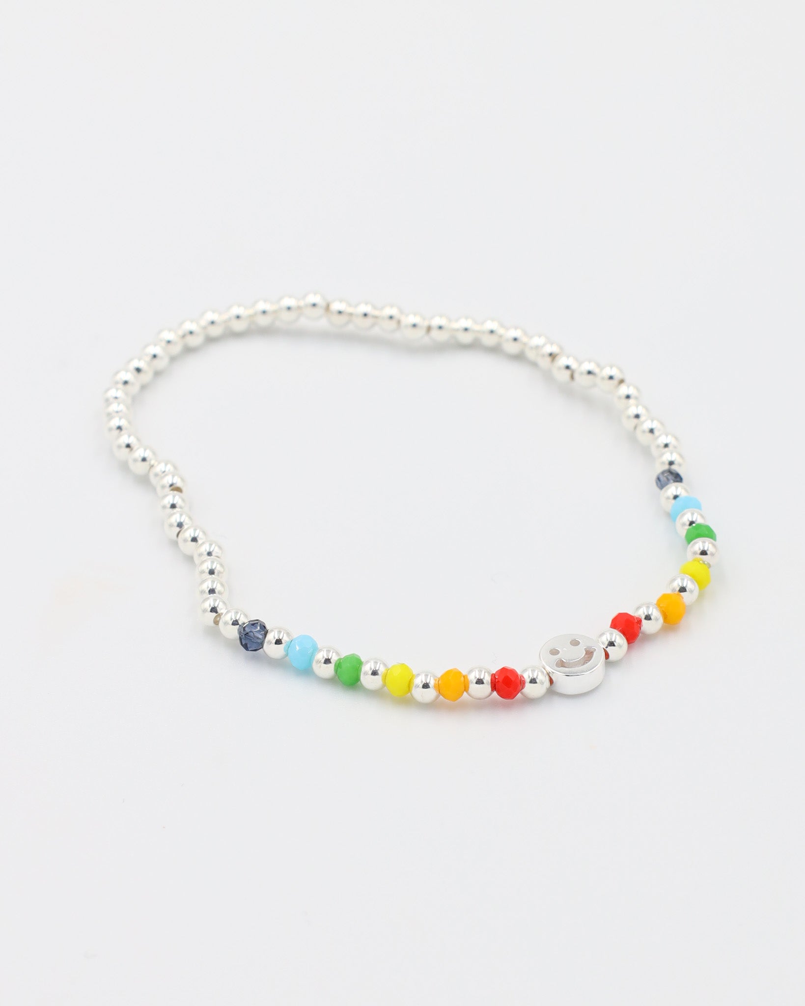 Adjustable sterling silver Pietro bracelet featuring a smiley charm and colorful accent beads, angled view.
