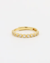 A gold-colored ring with multiple gemstones set around its circumference.
