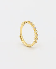 A gold-colored ring with multiple gemstones set around its circumference.