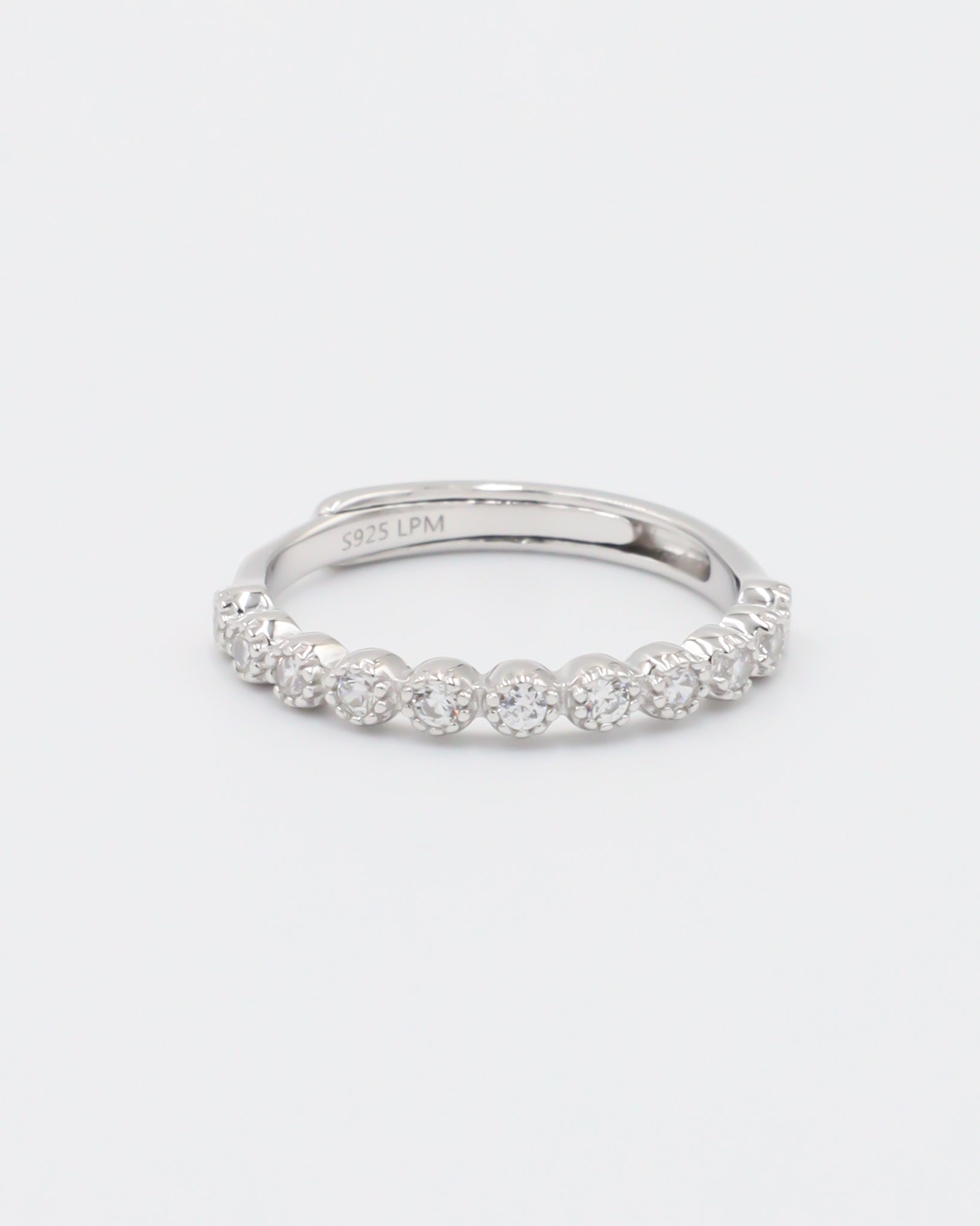 A silver ring with multiple stones set around its circumference.