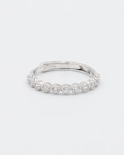 A silver ring with multiple stones set around its circumference.