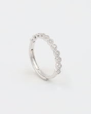 A silver ring with multiple stones set around its circumference.