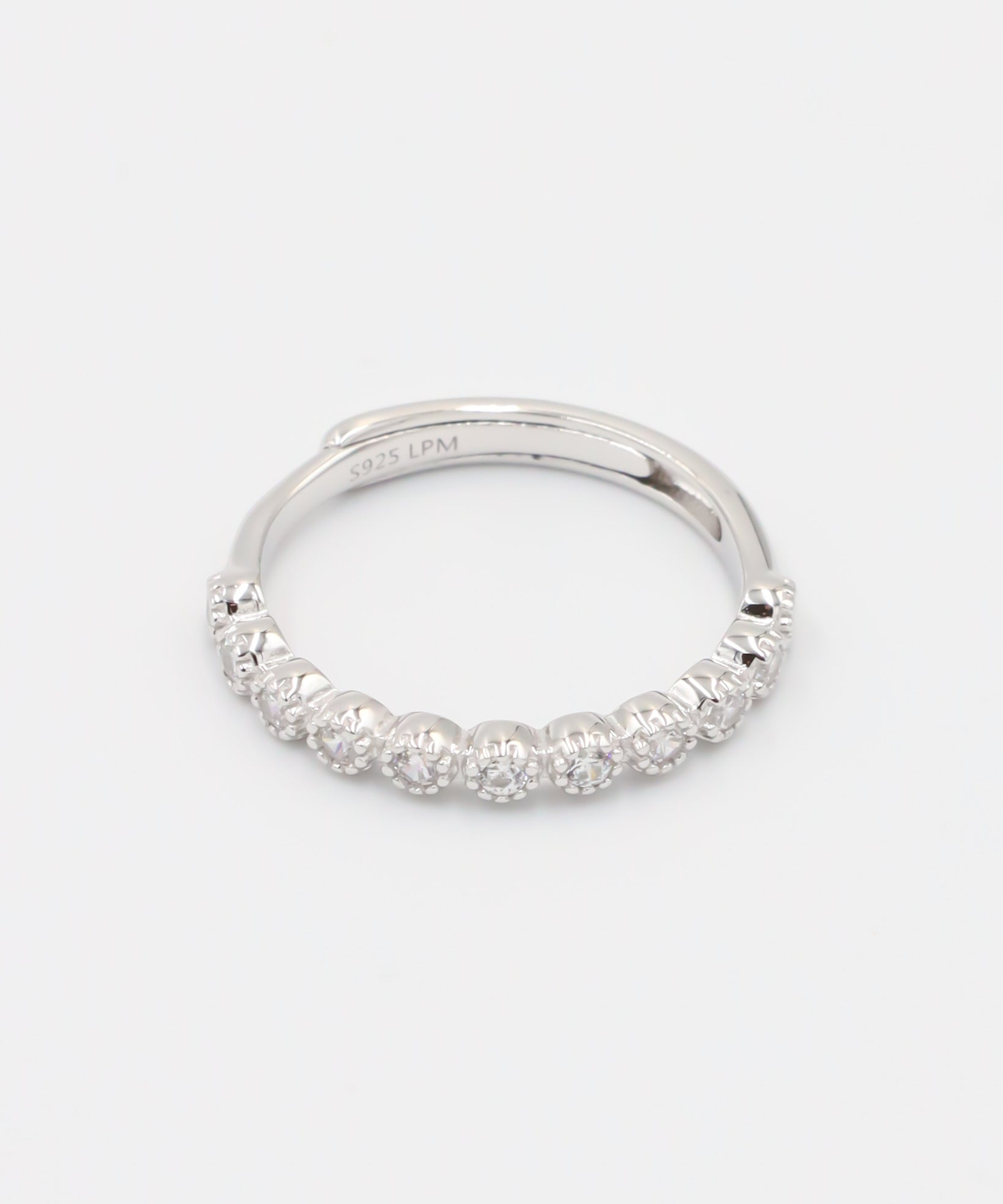 A silver ring with multiple stones set around its circumference.