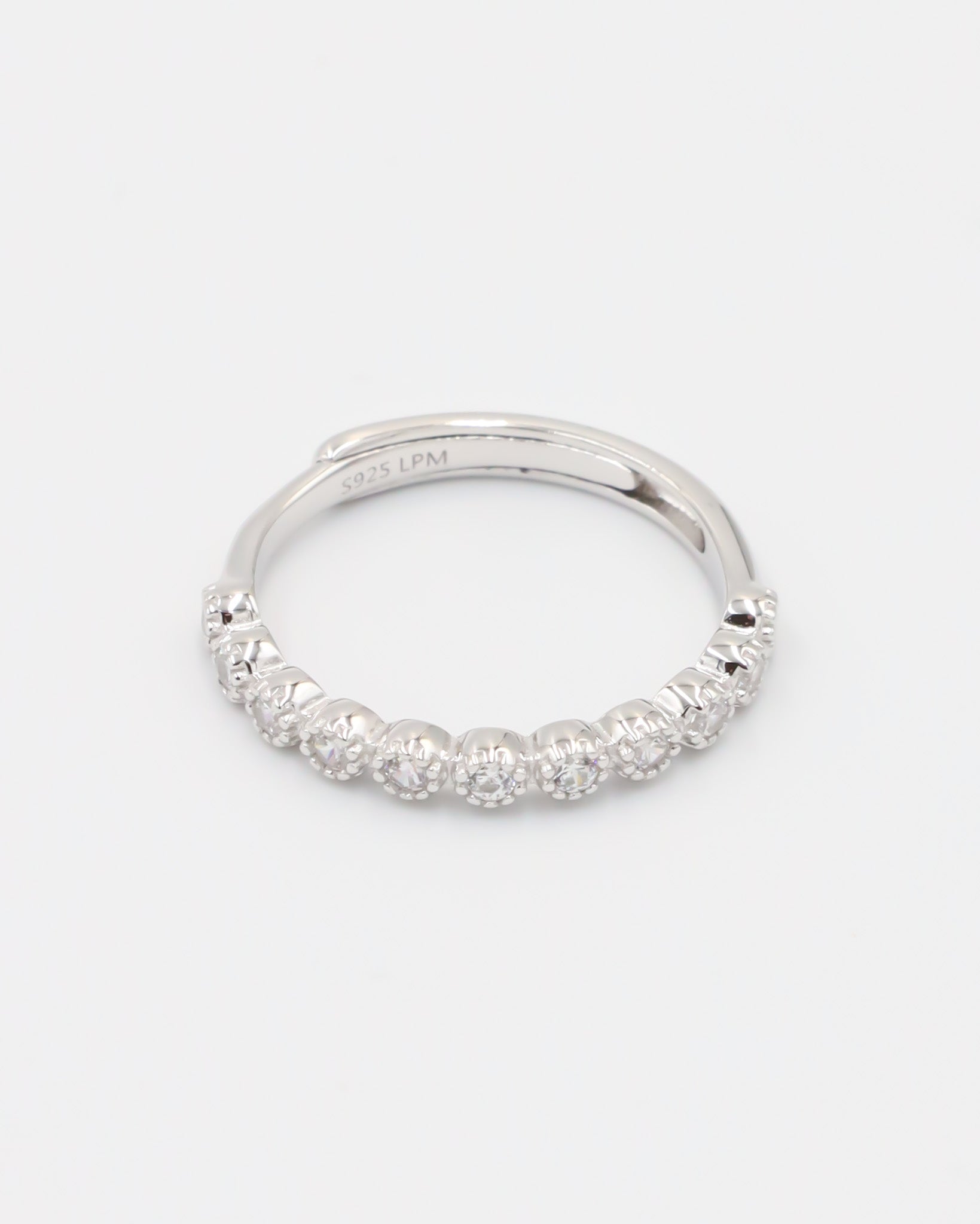 A silver ring with multiple stones set around its circumference.
