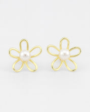 Gold flower-shaped earrings with pearl centers on a white background
