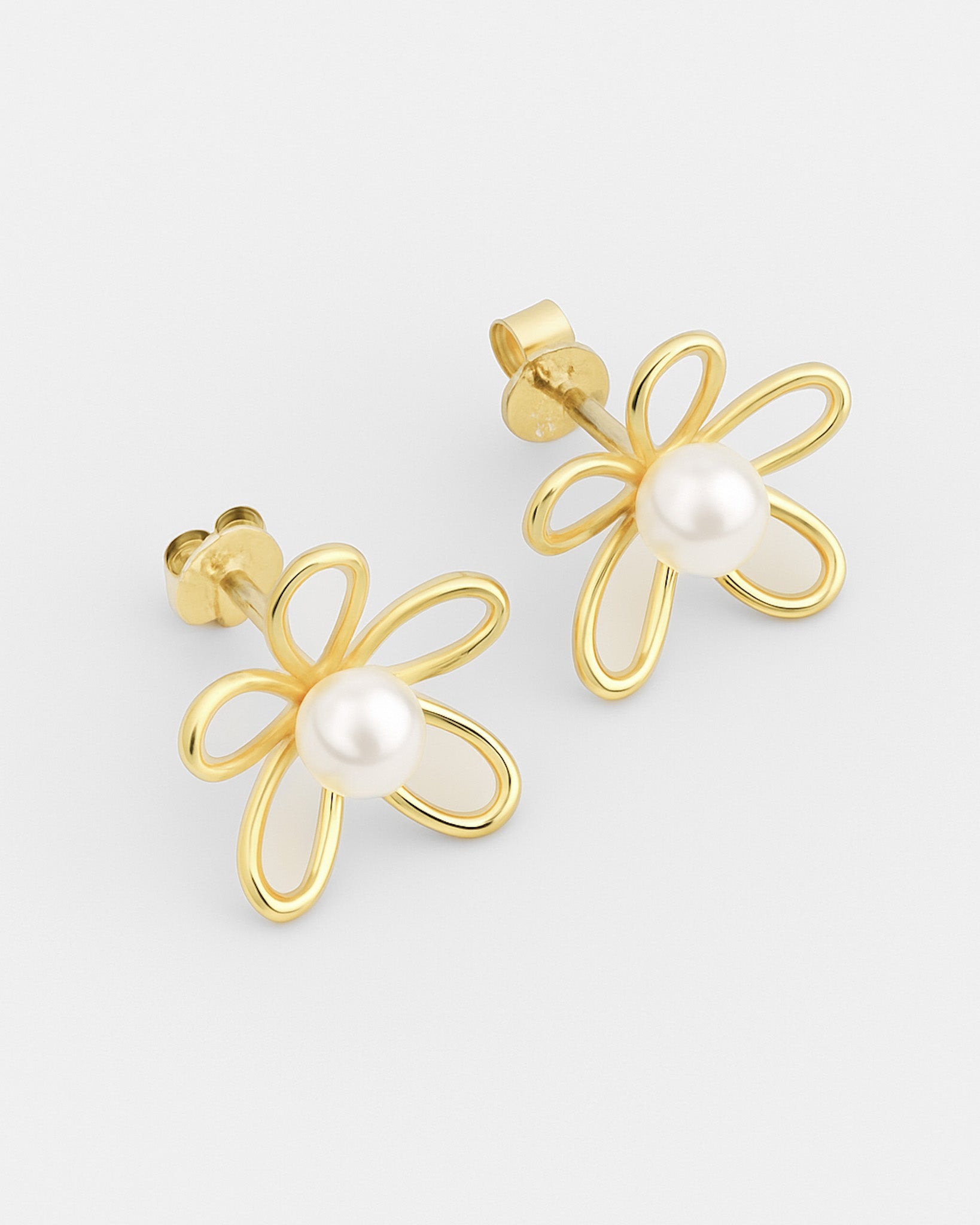 Gold flower-shaped earrings with pearl centers on a light gray background
