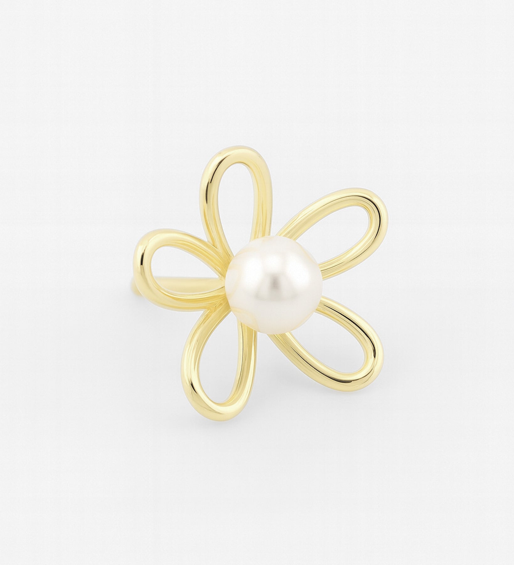 Gold flower-shaped earring with a pearl center on a light gray background