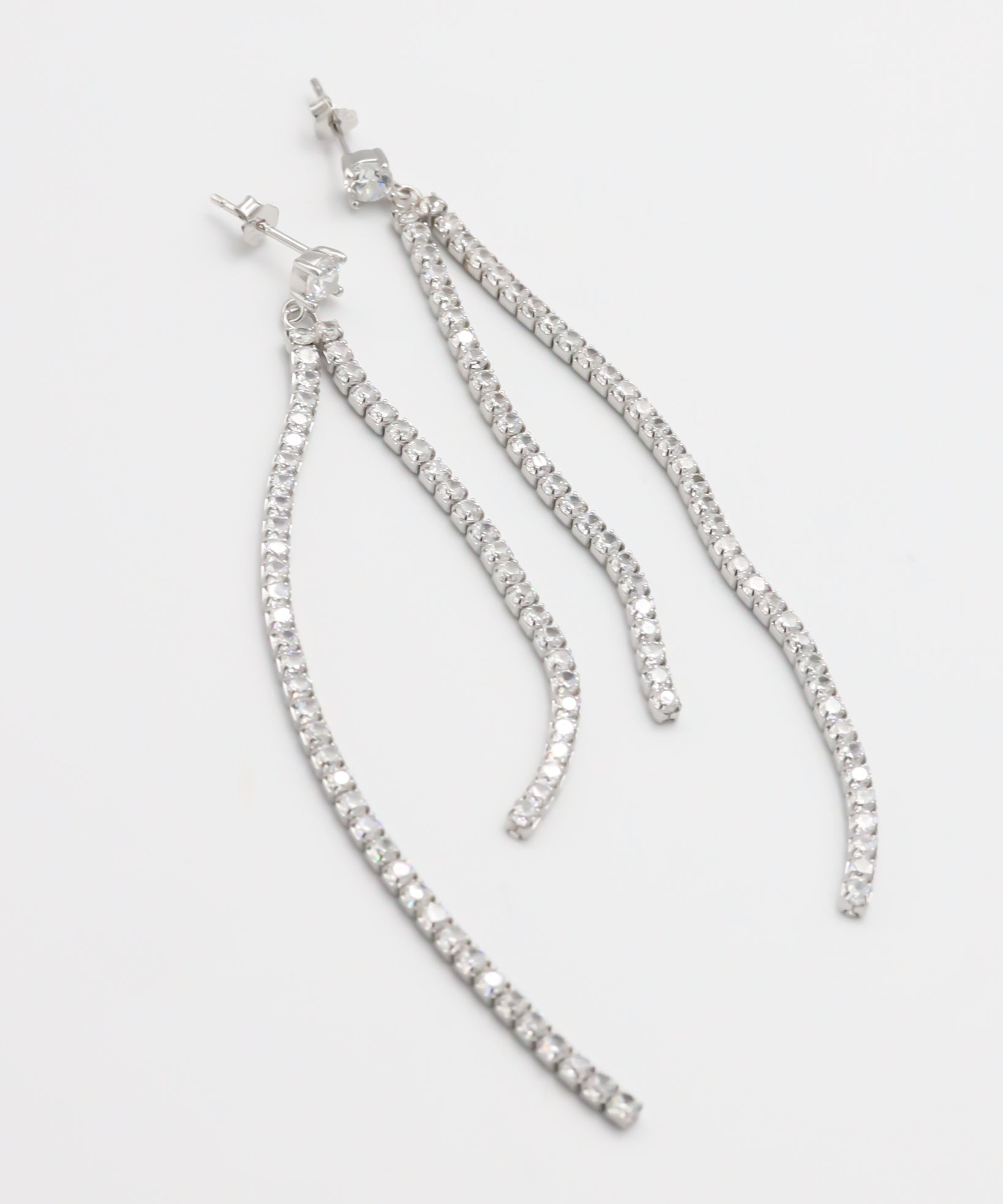 A pair of silver-colored stud earrings with small crystal embellishments.
