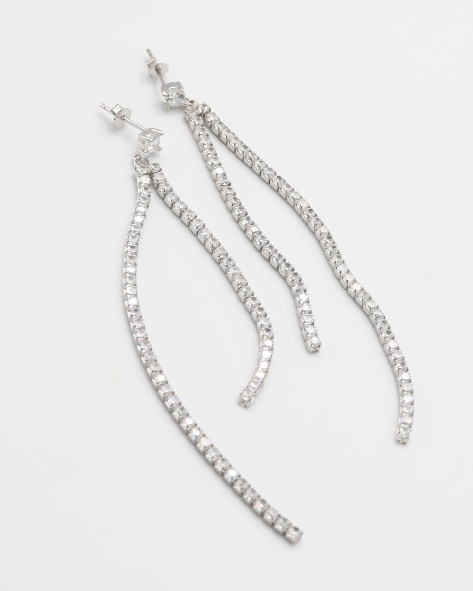 A pair of silver-colored stud earrings with small crystal embellishments.