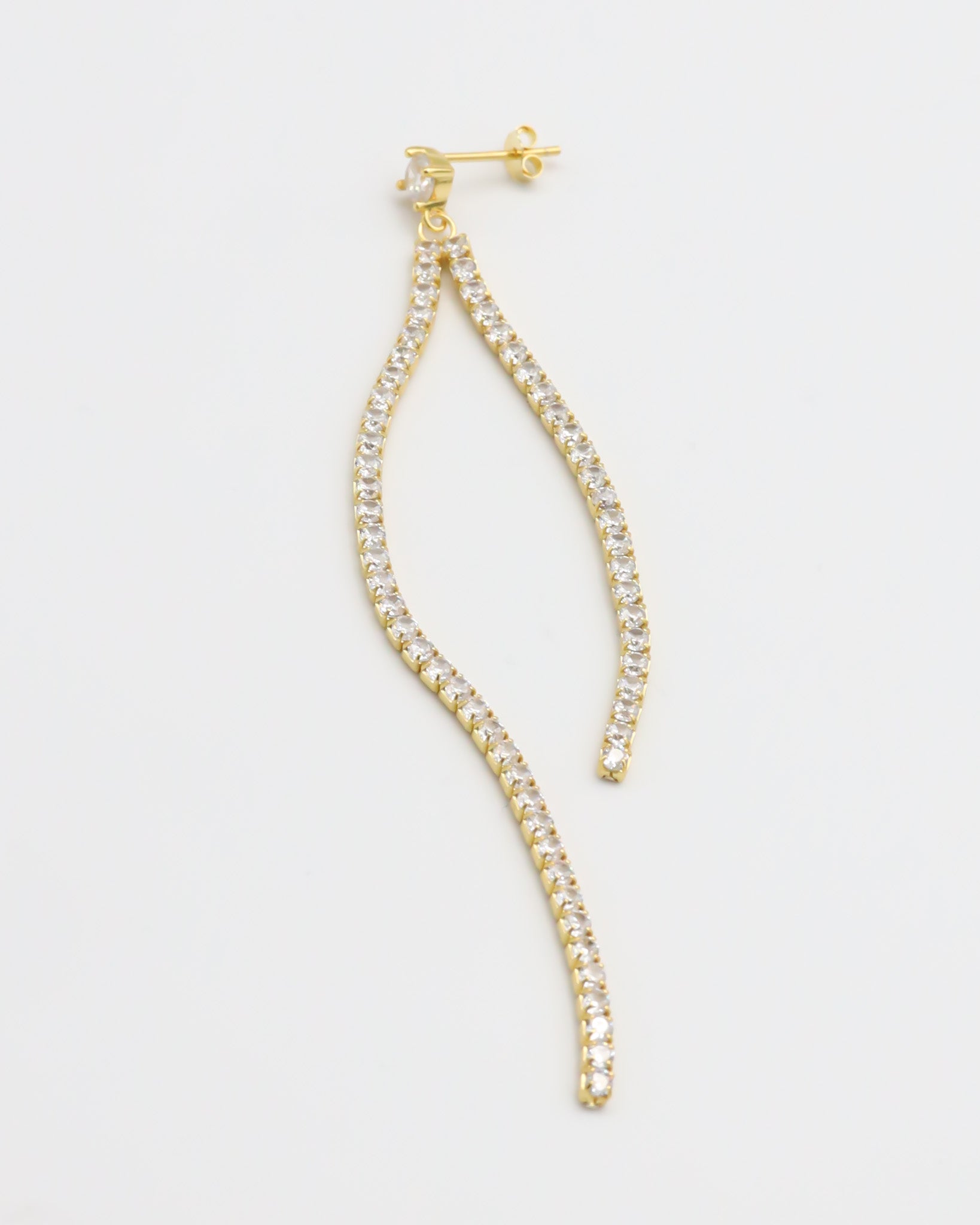 Gold colored silver earring with dangling crystal embellishments.