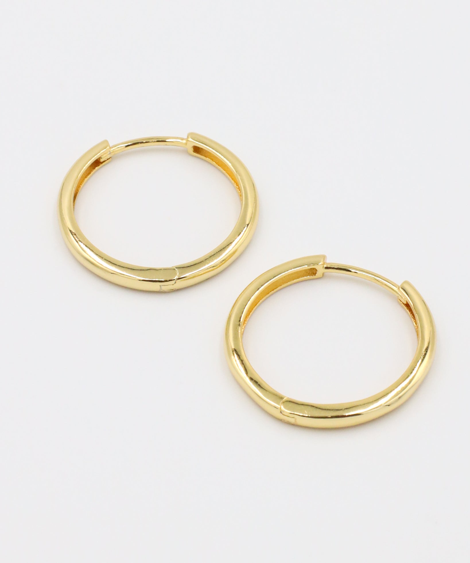 Side view of Rachele hoop earrings, crafted from gold-plated sterling silver, showing the classic hoop shape.
