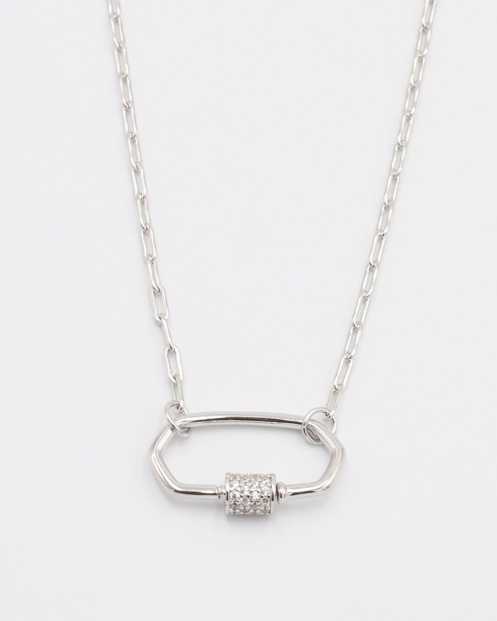 A silver necklace with a pendant featuring multiple stones in a geometric pattern.