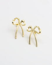 A pair of gold-colored ribbon-shaped stud earrings on a white background