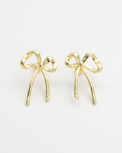 A pair of gold bow-shaped earrings on a white background