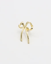 A single gold bow-shaped earring on a white background