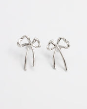 A pair of silver bow-shaped earrings on a white background