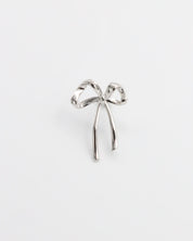 A single silver bow-shaped earring on a white background