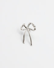 A single silver bow-shaped earring on a white background