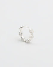 A silver hoop earring with a textured surface on a white background.