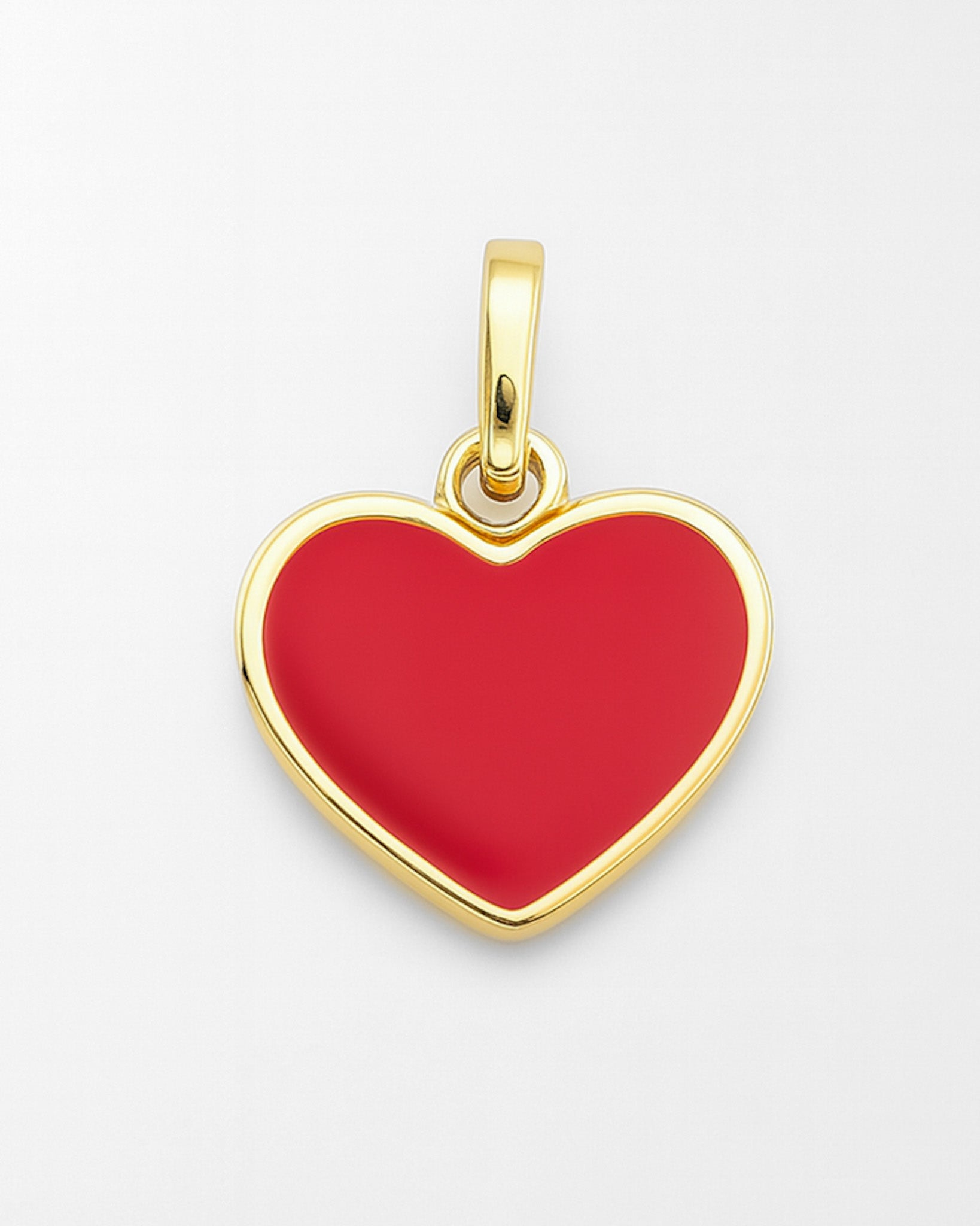 Gold heart-shaped pendant with red center on a white background
