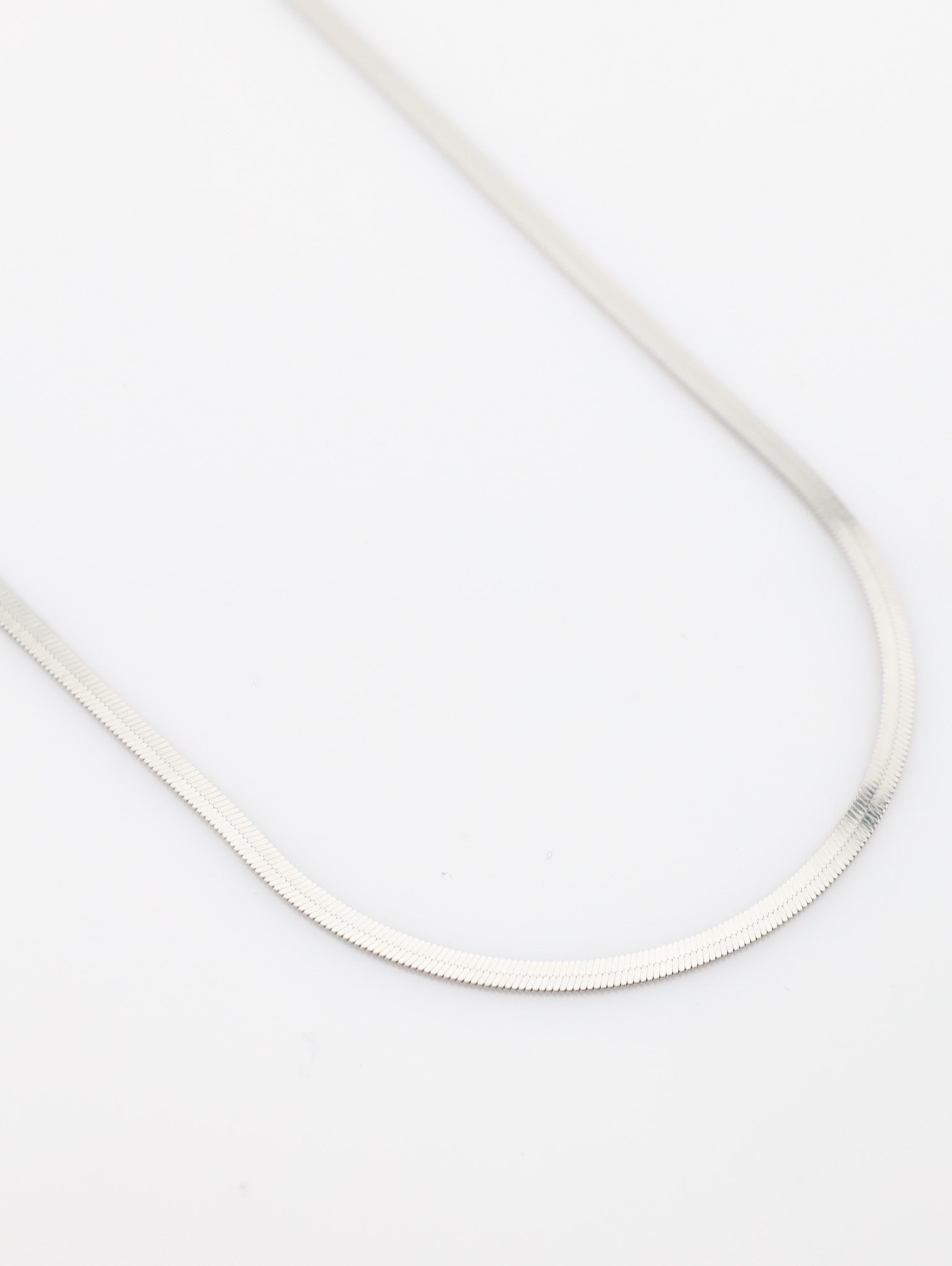 Thin white cable on a light gray background
