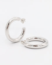 A pair of silver hoop earrings with a visible stud attachment, displayed against a white background.
